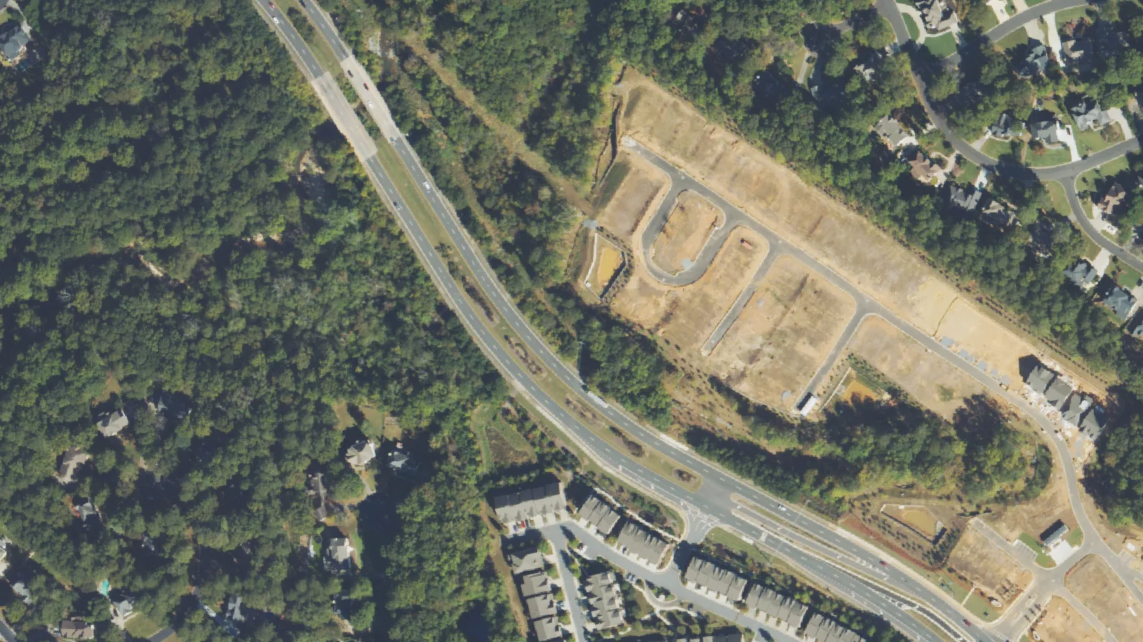 Homes and townhouses beside State Bridge Road in Johns Creek, seen from the air. The picture does not show the area as it is today.